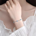 Blue diamond heart necklace and bracelet set with adjustable chain on display