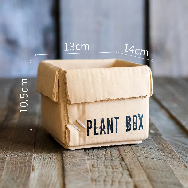 Cement flowerpot with brown paper box design featuring drainage holes