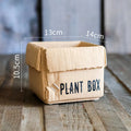 Cement flowerpot with brown paper box design featuring drainage holes