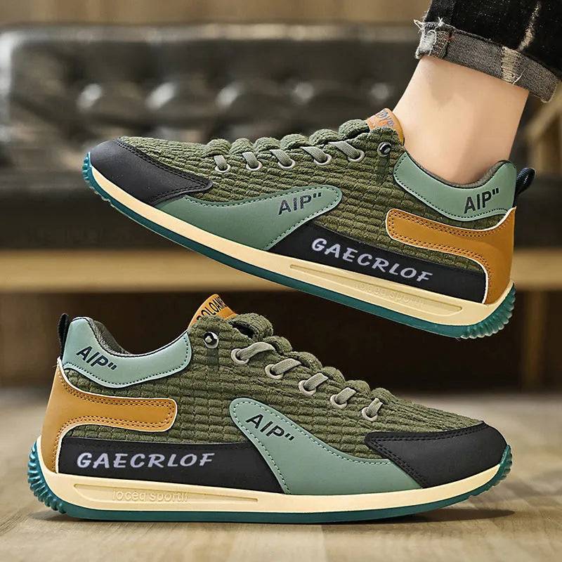 Men's grey and green mesh running shoes with round toe and lace-up design shown from side view