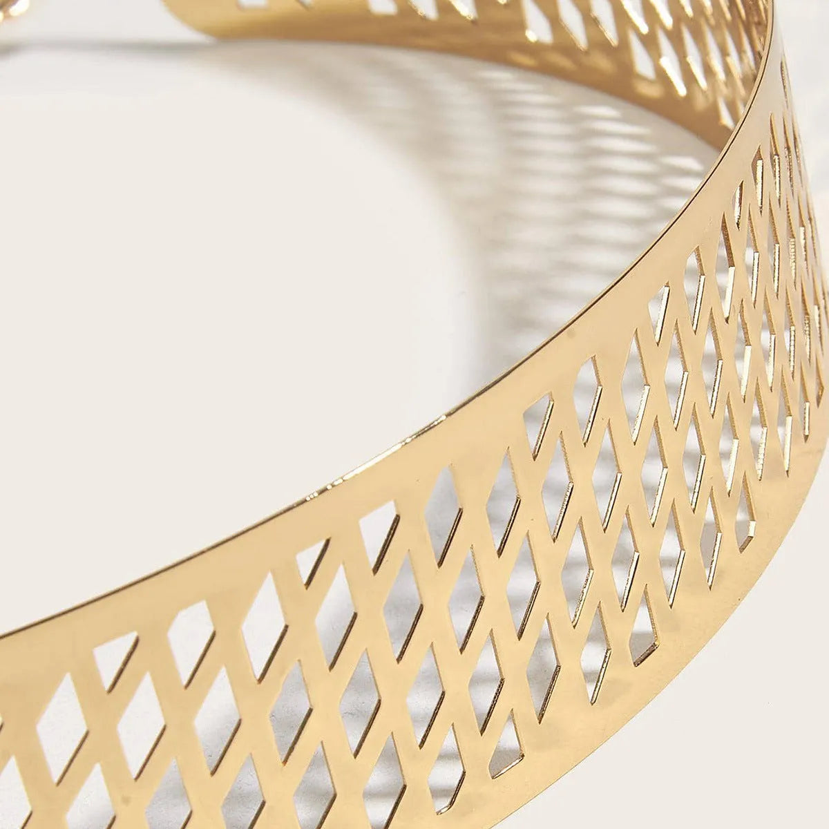 Gold iron waist seal belt with lantern head punching detail, showing hook fastener.