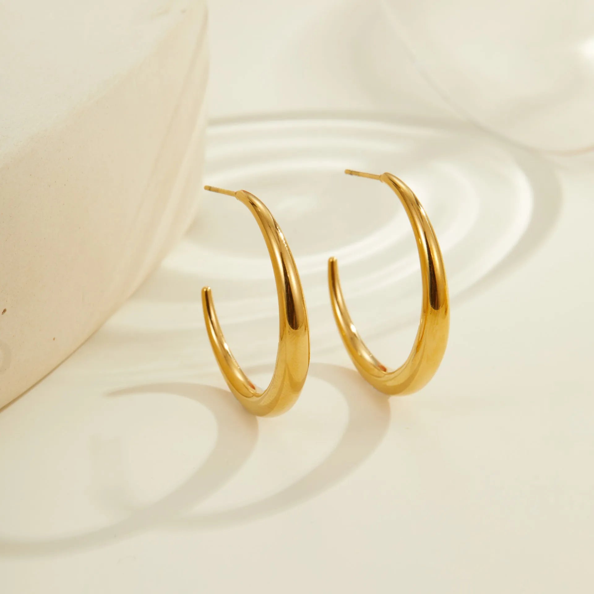 Titanium steel hoop earrings with 18K gold plating in small and large sizes