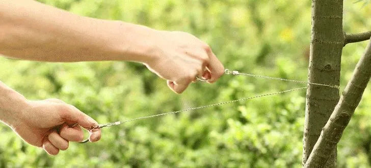 Survival wire saw with leather hand case showing steel wire construction and compact design