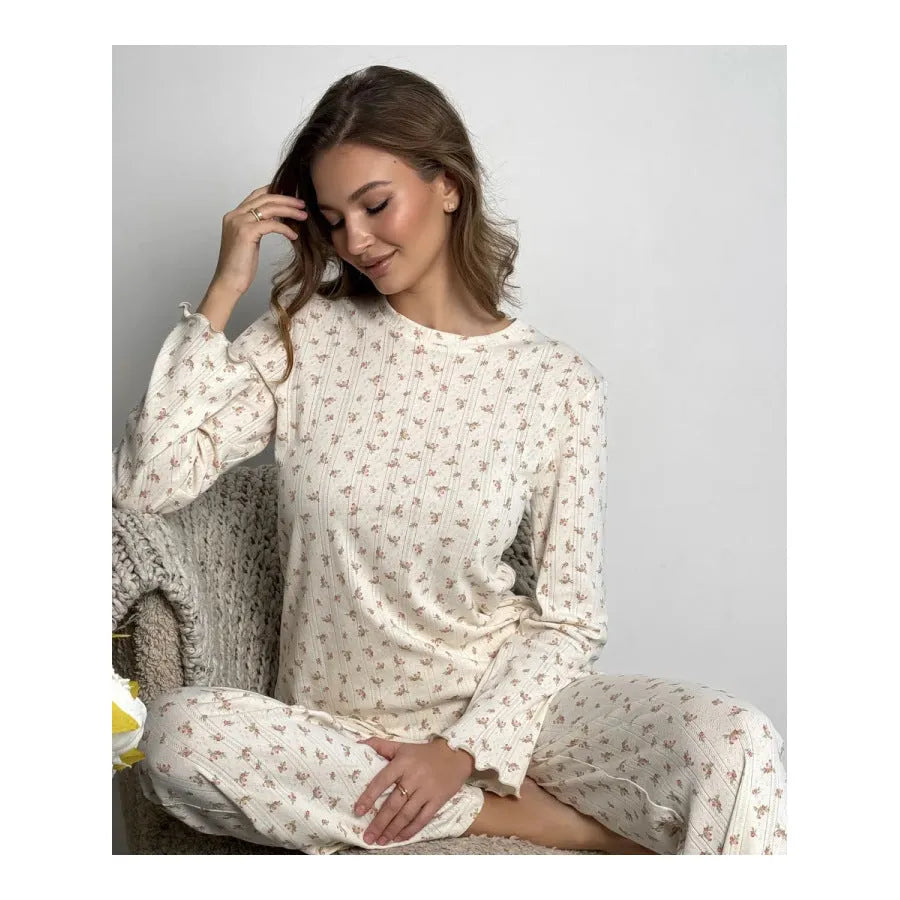 White floral print women's bell sleeve top and wide leg trousers suit on hanger