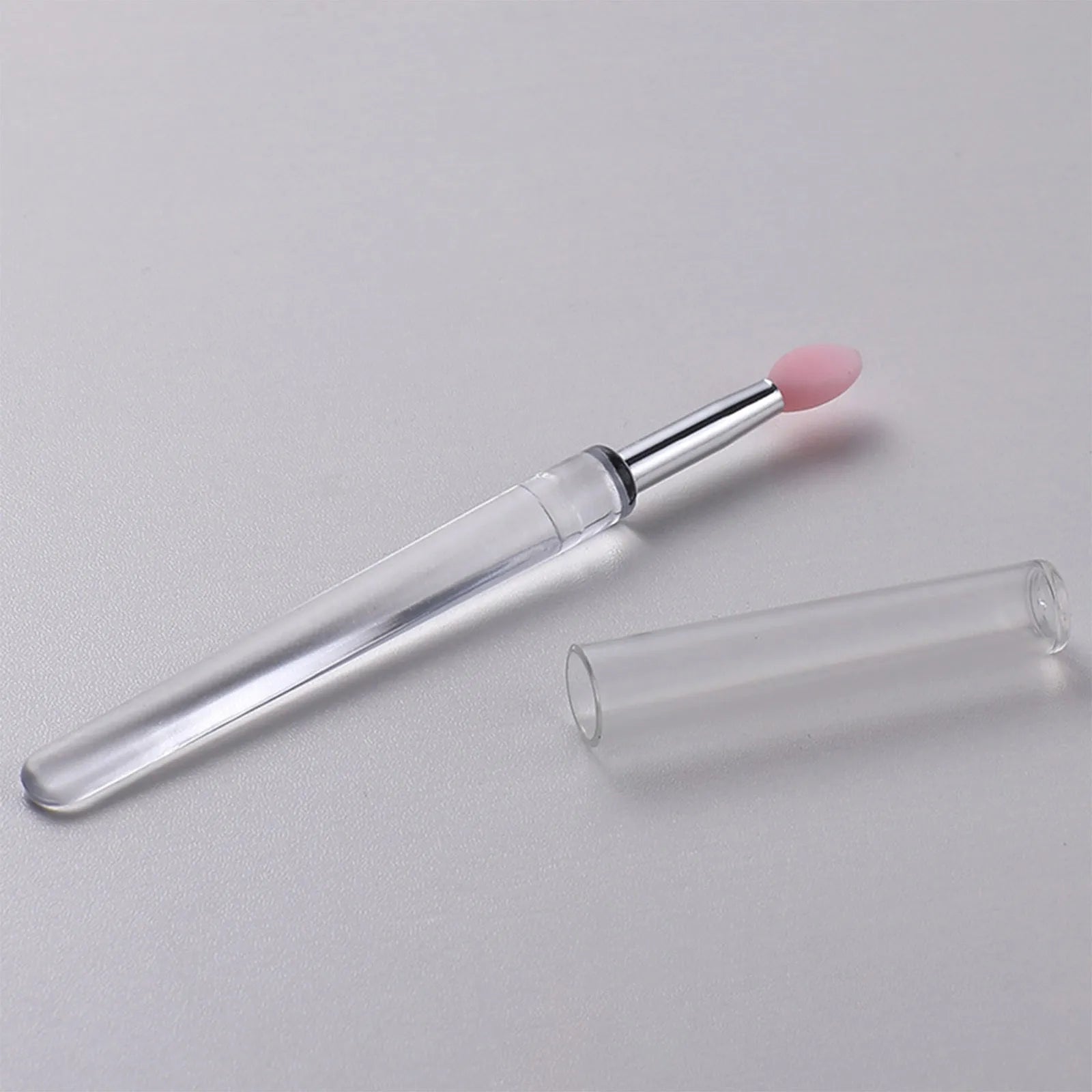 Set of silicone lip brushes with caps in various colours including blue, pink, and purple.