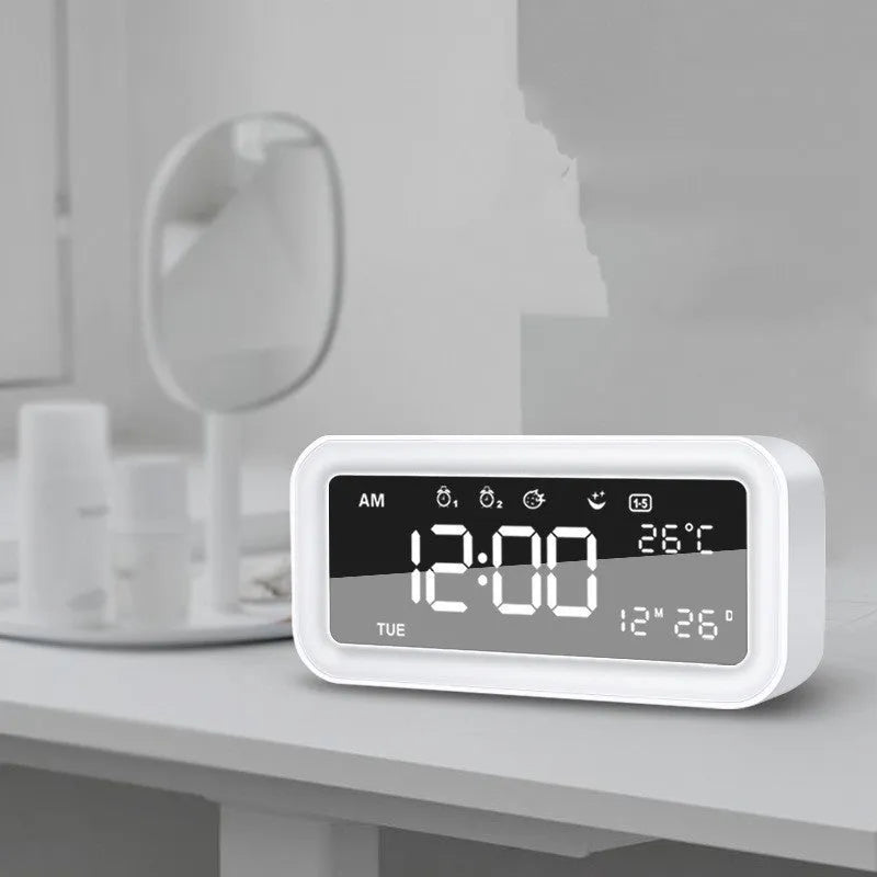 Blue rectangular LED atmosphere light alarm clock with digital display on a desk.