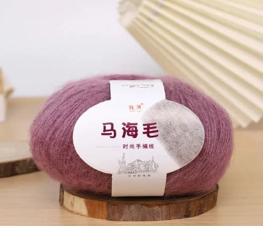DIY mohair scarf weaving kit showing one wool ball and a selection of 34 colour options including white, pink, blue and green.