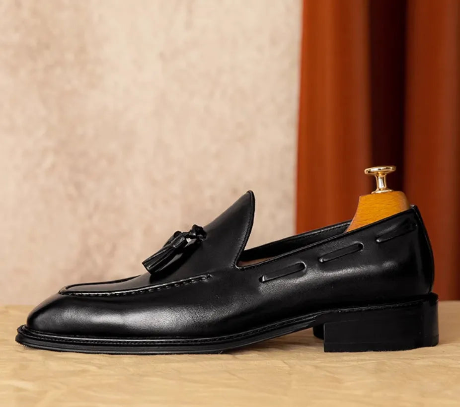 Men's brown leather loafers with fringed detail and slip-on design on rubber sole