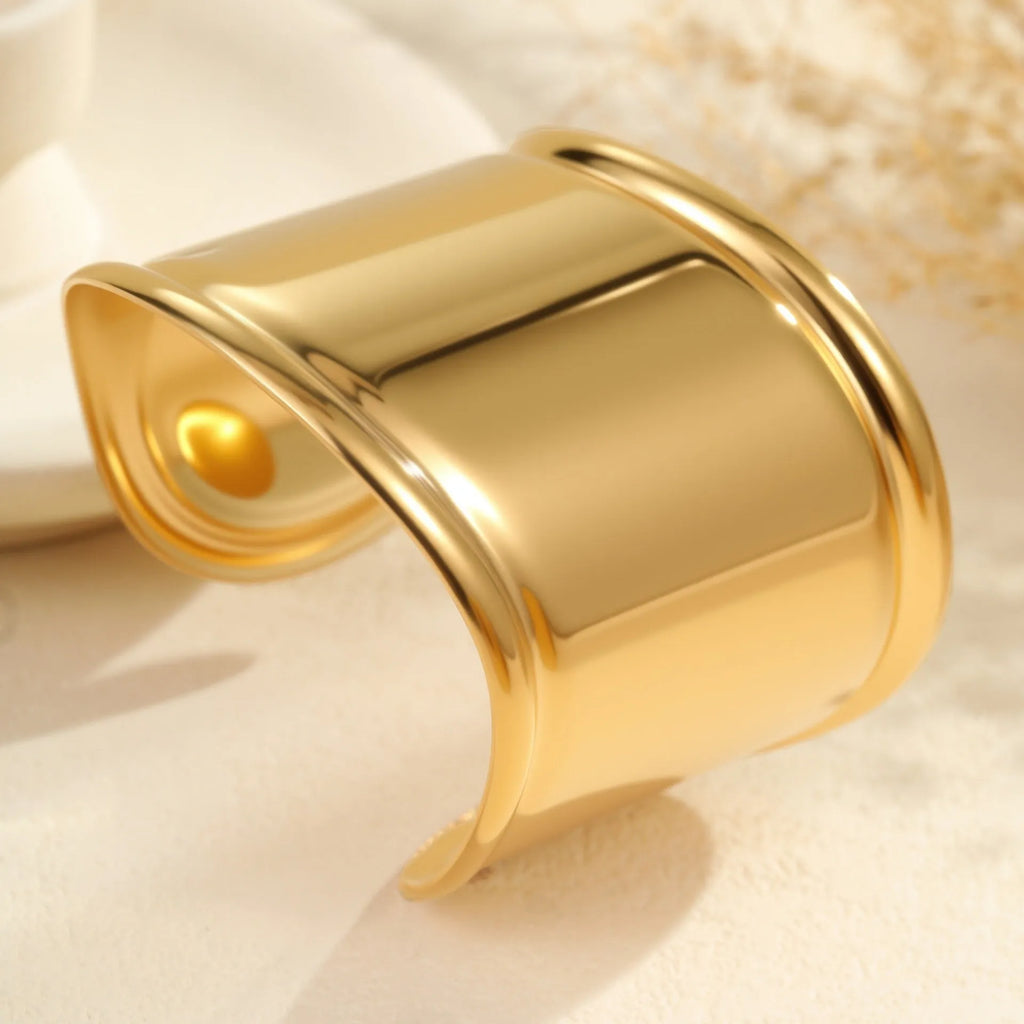 Women's gold plated stainless steel bracelet with exaggerated wide geometric wave design and niche opening