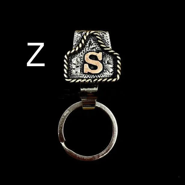 Handmade metal cow tag belt key holder keychain on a key ring, showing the metal loop and tag design.