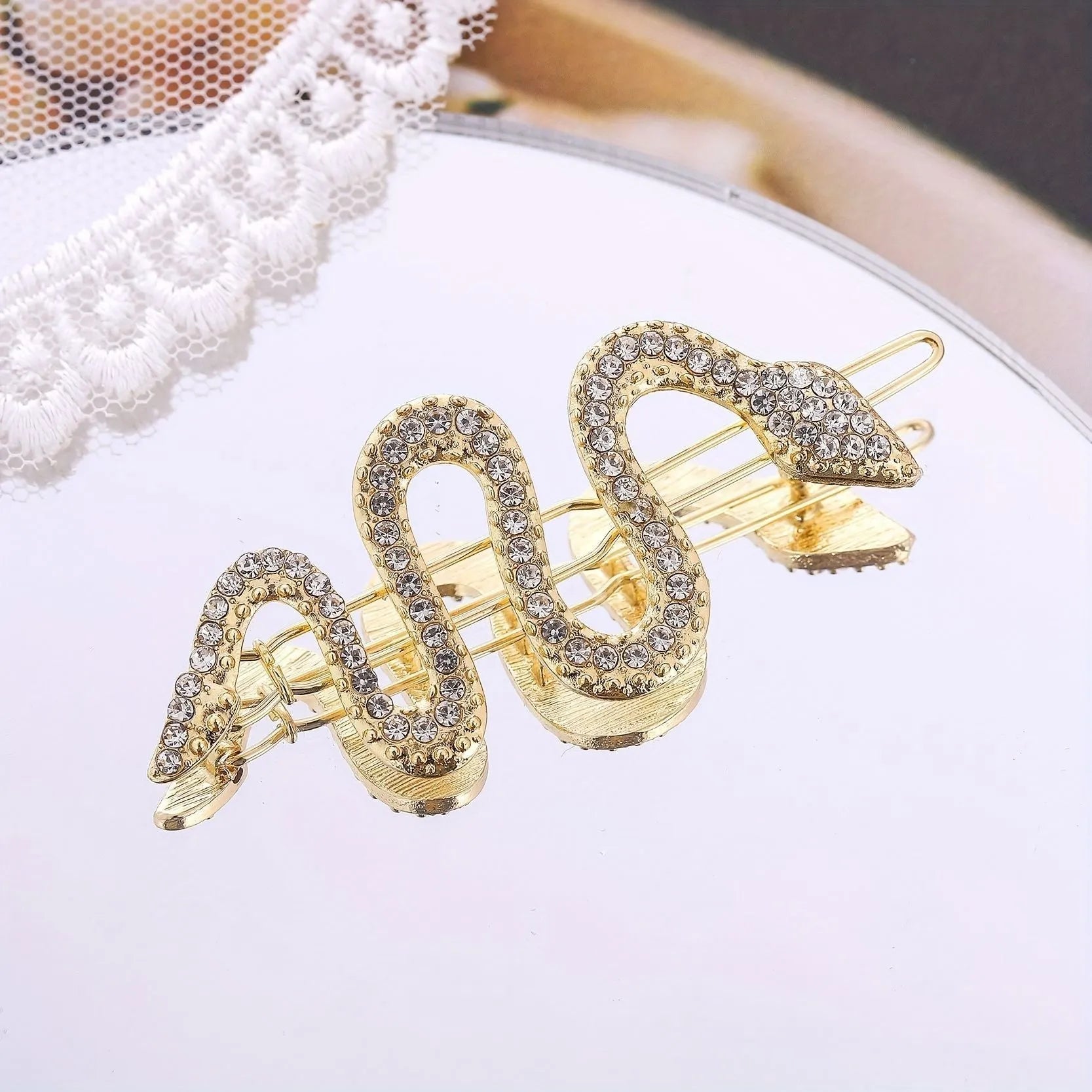 Gold and silver vintage snake hair barrettes with rhinestone detailing on alloy clips.