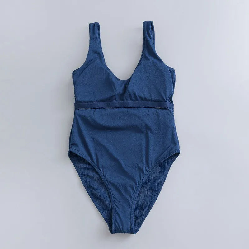 Women's navy blue solid colour one-piece swimsuit with triangle shape and chest pads on a mannequin.