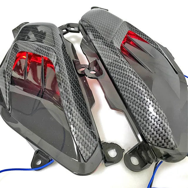 Pair of Yamaha NMAX replacement LED side lamps with carbon fibre decoration, showing blue or red light option.