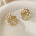 Gold-coloured copper earrings with a small bead flower basket design.