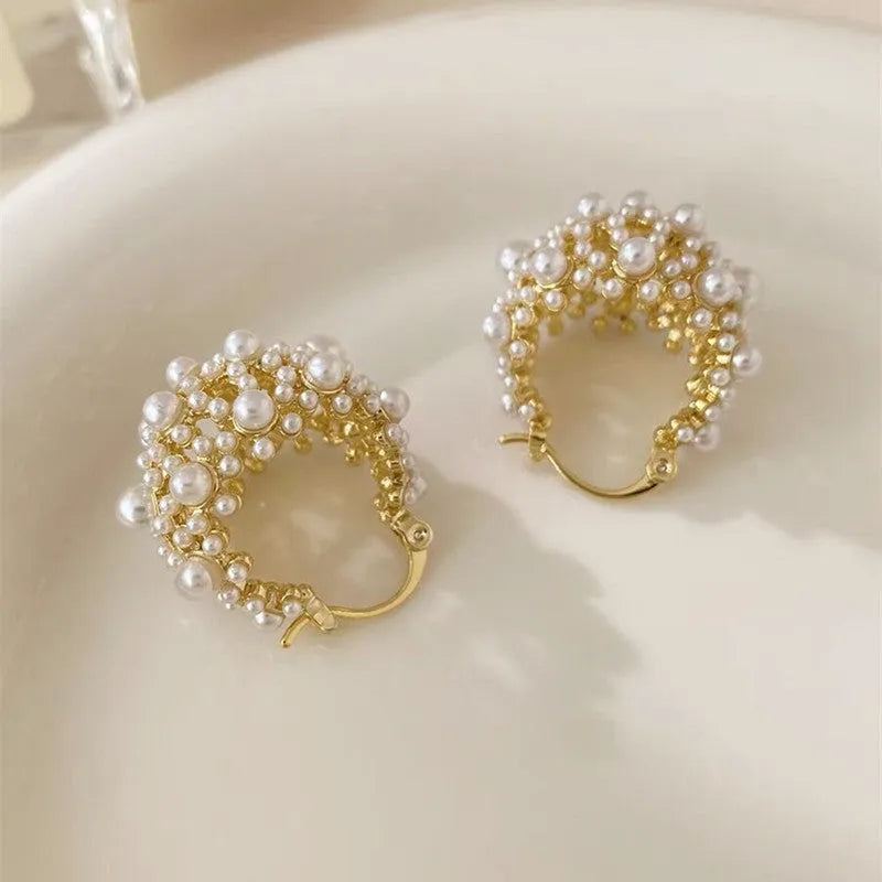Gold-coloured copper earrings with a small bead flower basket design.