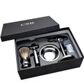 CSB men's shaving kit with chrome razor and stand, badger hair brush, soap bowl, and blades on black box.