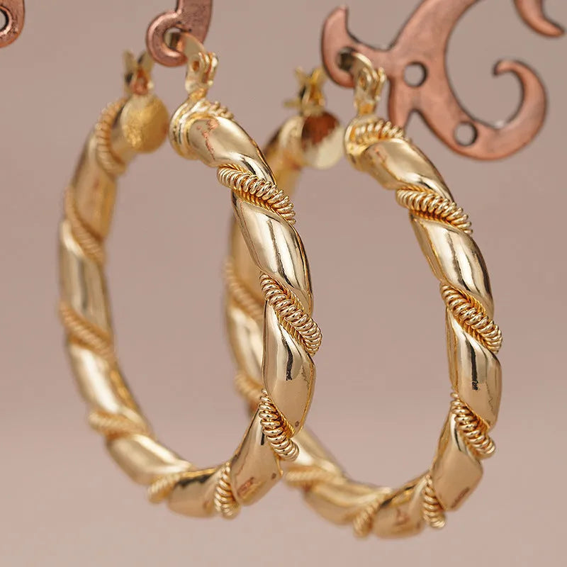 Geometric women's copper earrings with ring and line details in a gold colour.