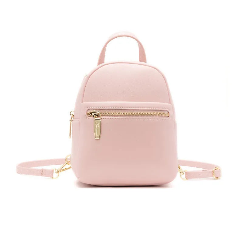 Soft black PU mini backpack with front pockets, shown open to reveal internal mobile phone sleeve and zipper compartment.