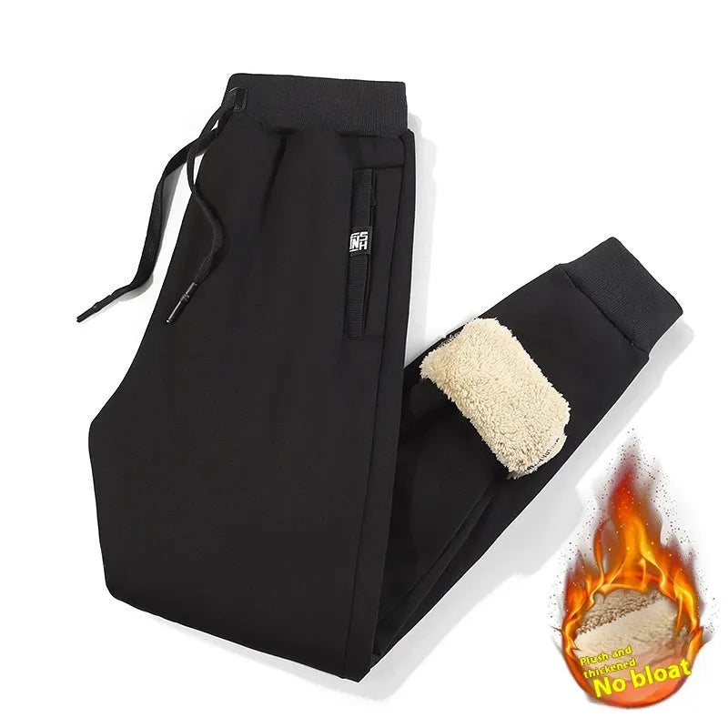 Men's grey oversized fleece-lined cotton track pants with drawstring waist on a hanger.