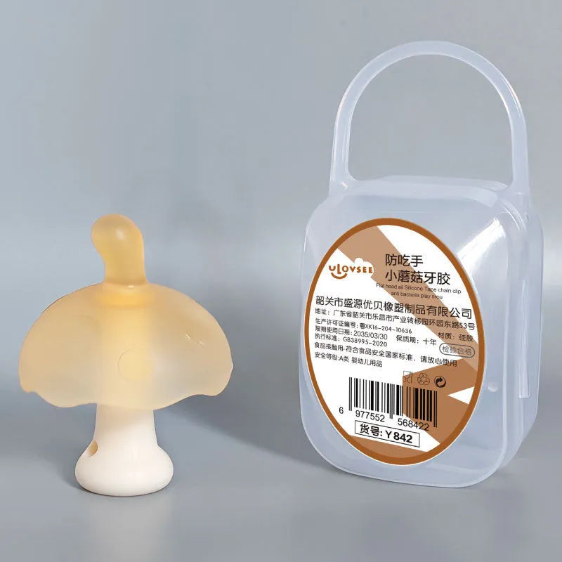 Small mushroom-shaped pink chewing gum inside a transparent box with a silver chain attached.