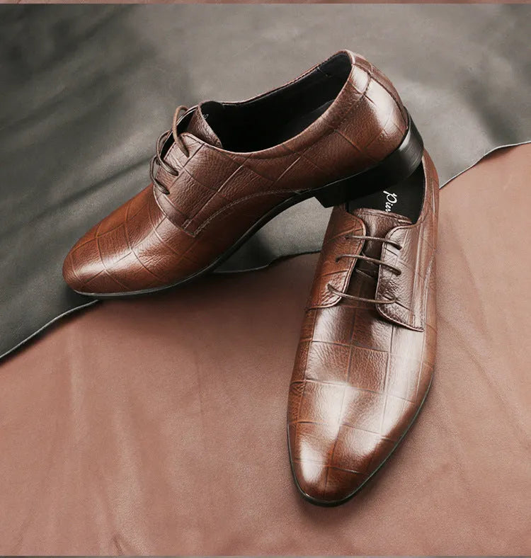 Men's black leather derby shoes with pointed toe and checkered pattern on a white background.