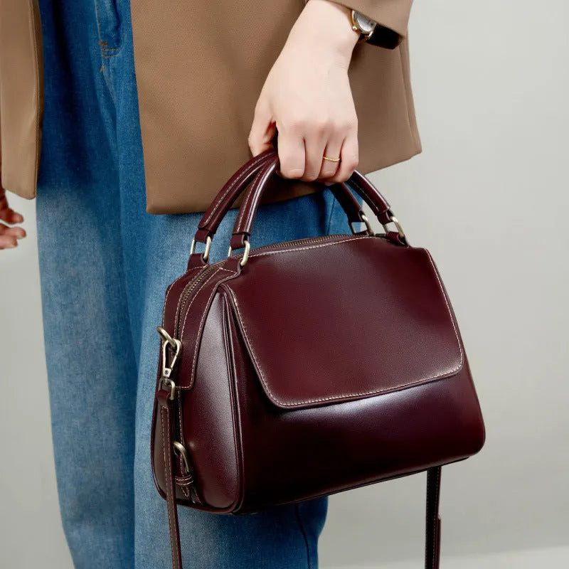 Genuine leather crossbody tote bag in a cross square shape with double straps and internal organiser pockets.