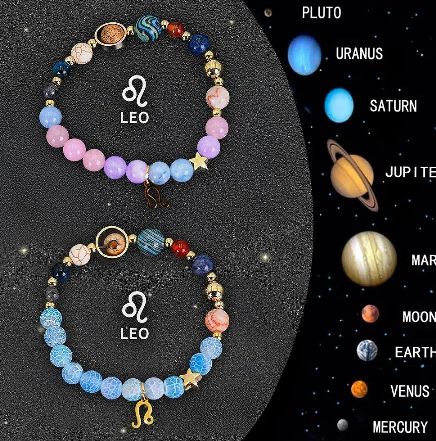 Set of two natural stone beaded bracelets with zodiac sign charms on a white background.