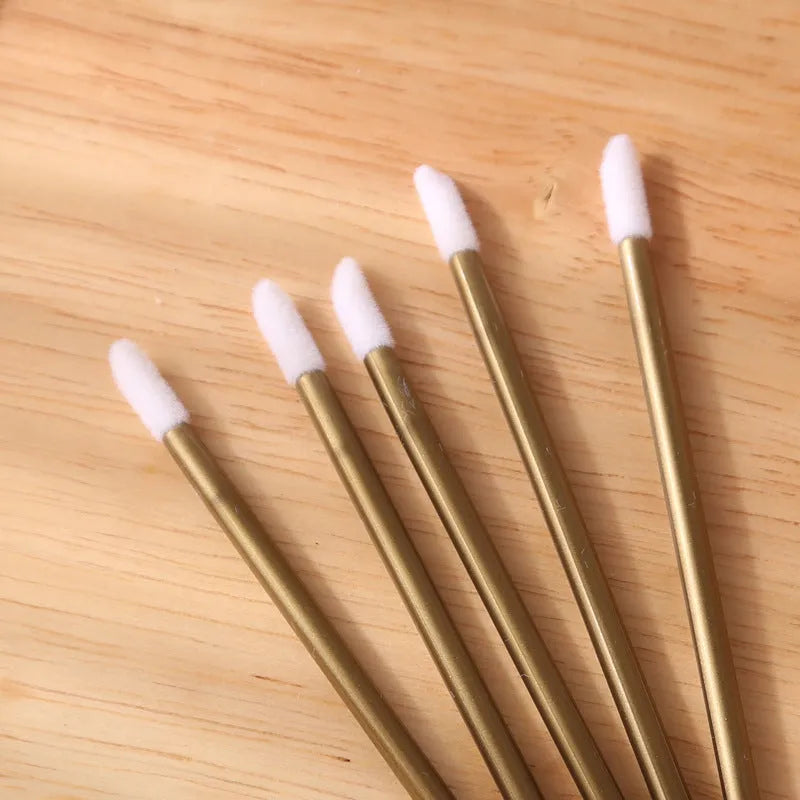 Disposable lip brush applicators with flocked heads in multiple handle colours on white background