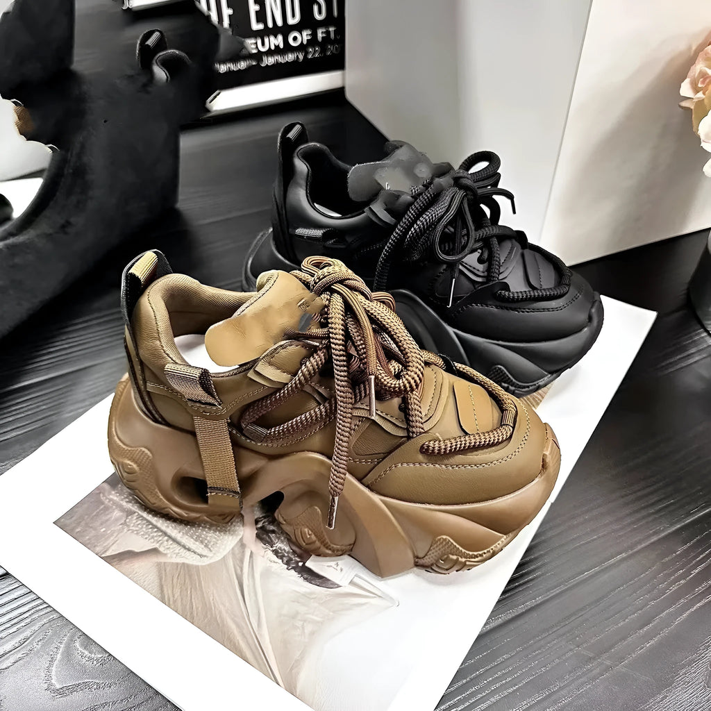 Women's casual wedge sneaker in synthetic leather with cross-strap detail and a thick platform sole.