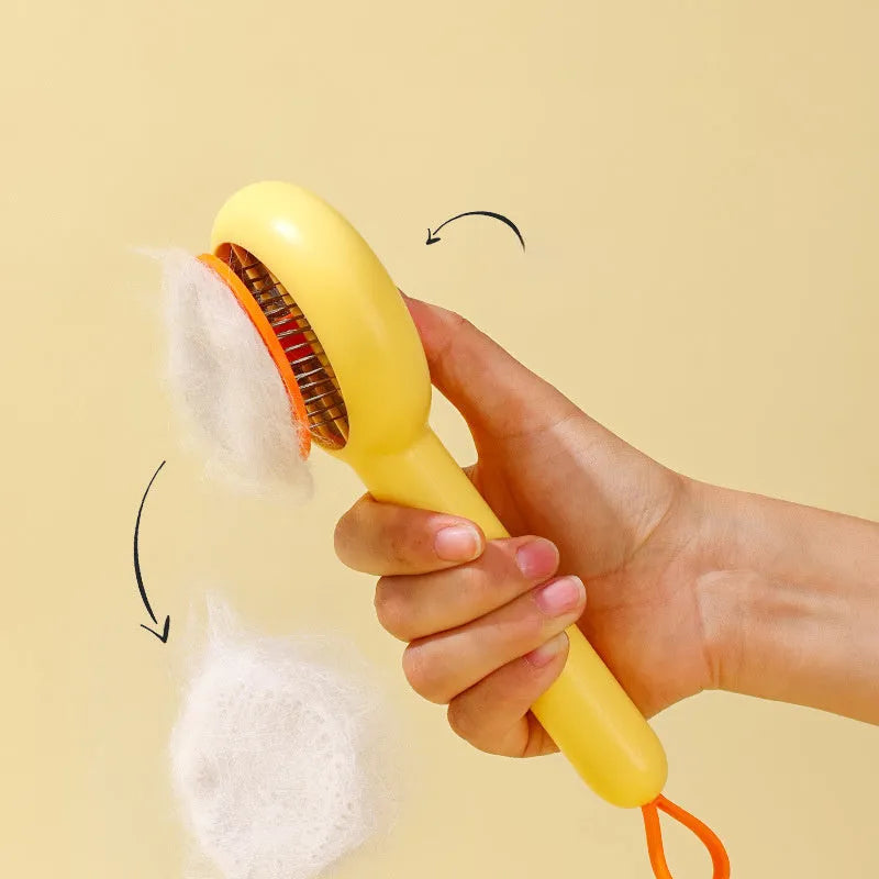 Yellow and white pet grooming comb with duck design and needle teeth for cats and dogs.
