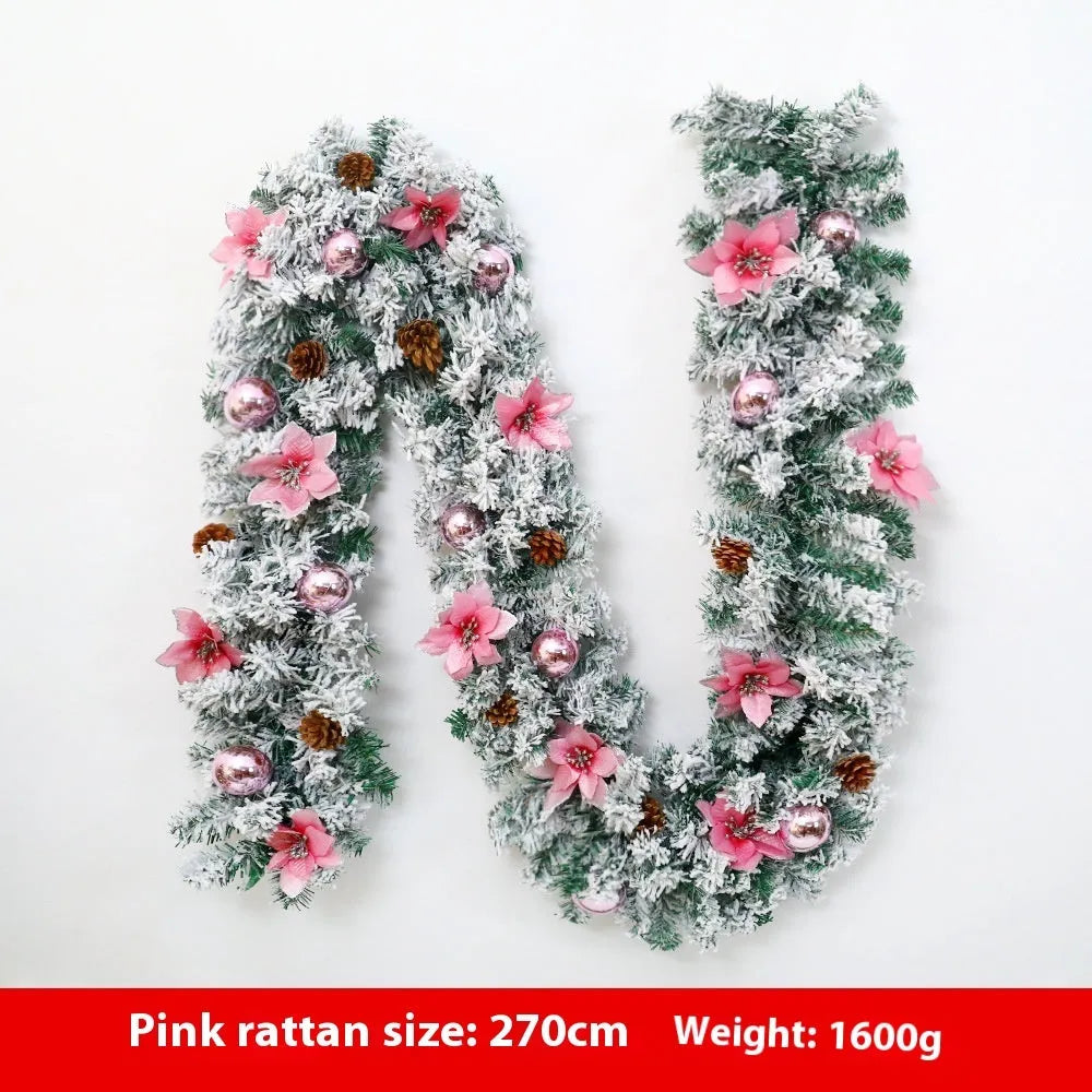 Snow-flocked Christmas rattan garland vine in red, draped on a mantelpiece.
