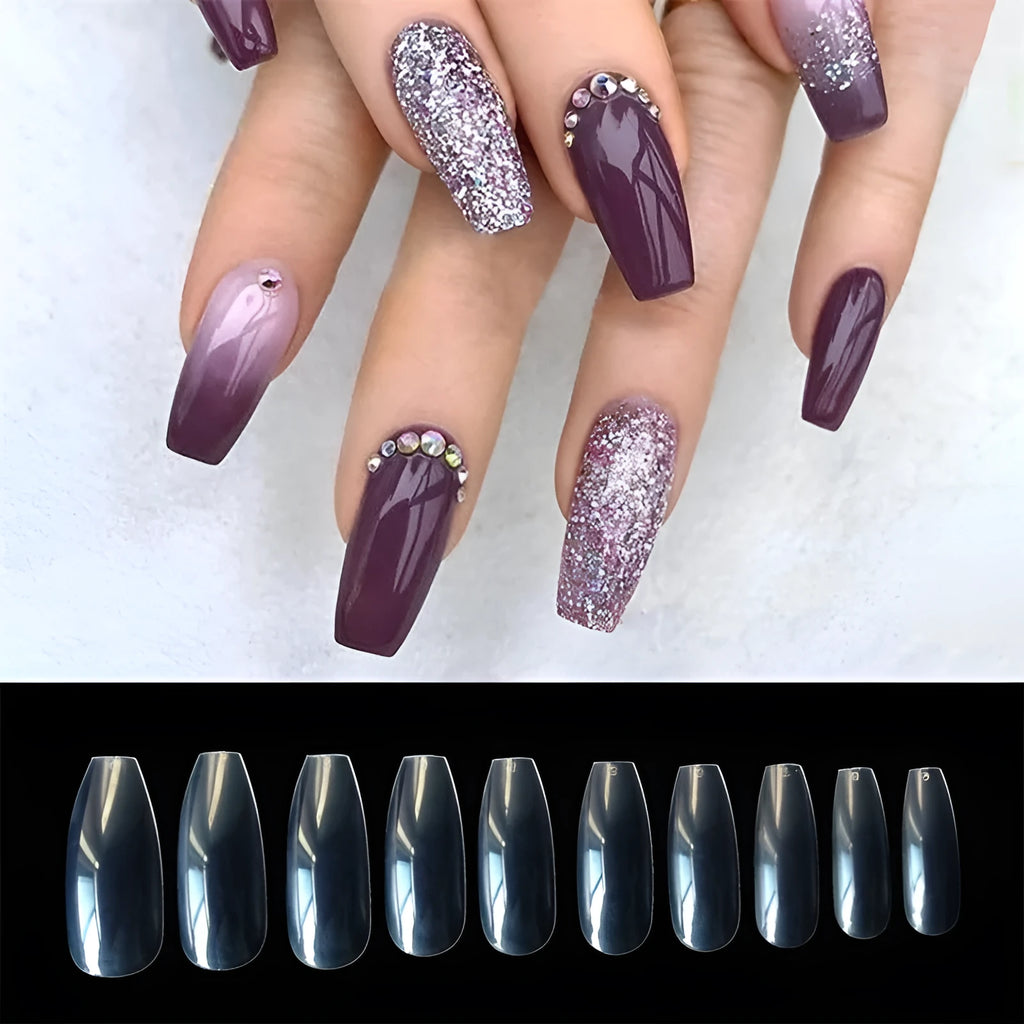 500 clear acrylic false nails in assorted sizes arranged next to application brush and bottle.