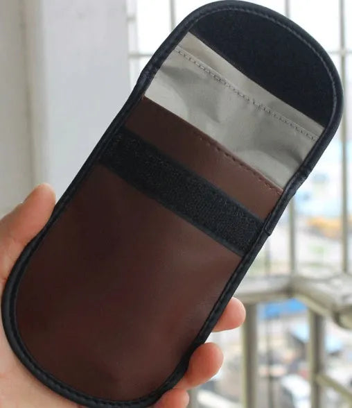 Black microfiber Faraday cage pouch for blocking car key and phone signals, sized 13.5 by 9.5 centimetres.