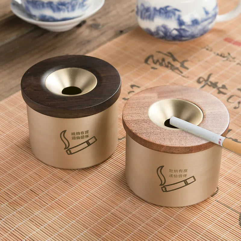 Retro-style brass ashtray with a wooden lid, shown in a home living room setting.