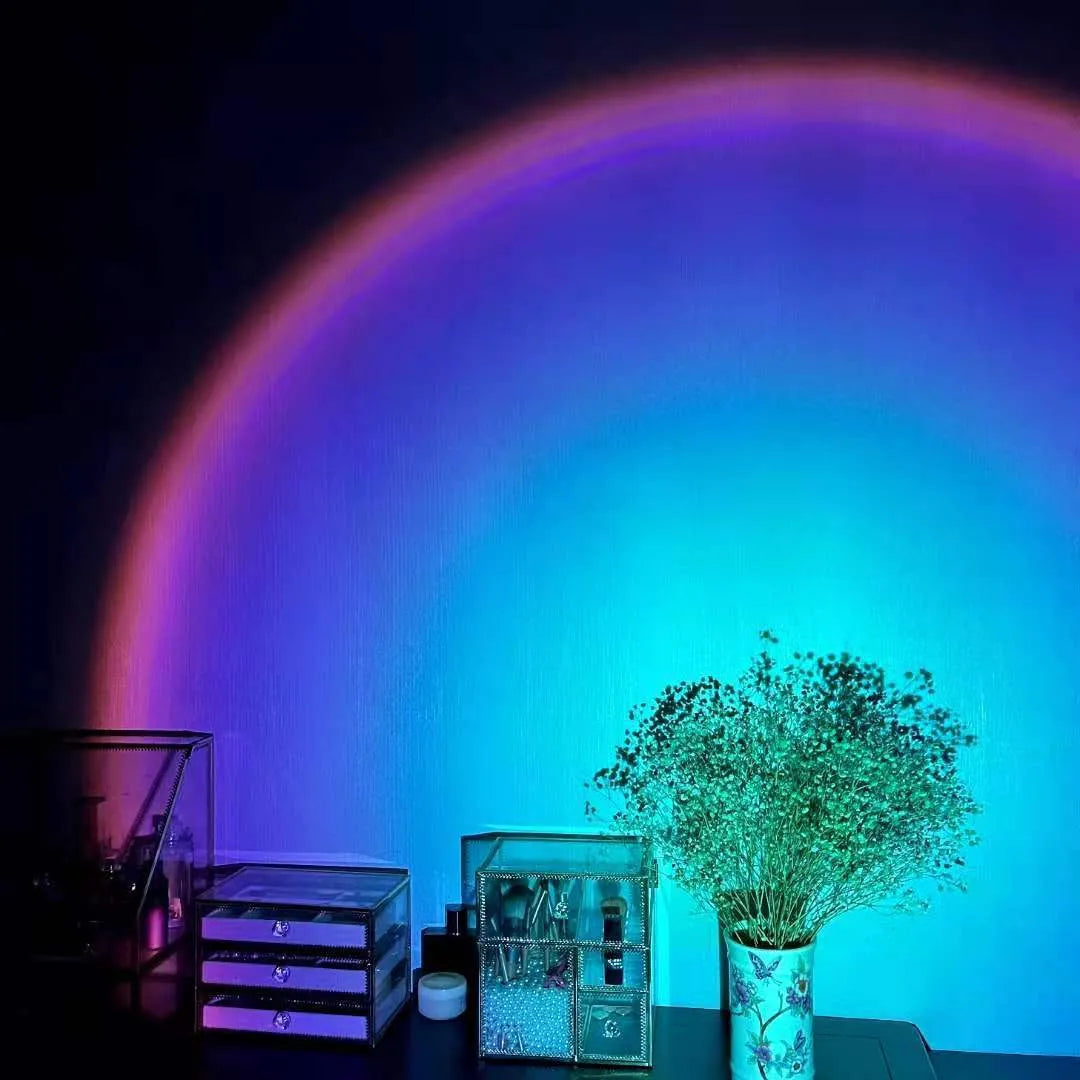 Rechargeable sunset projection lamp showing rainbow atmospheric lighting with USB power connector