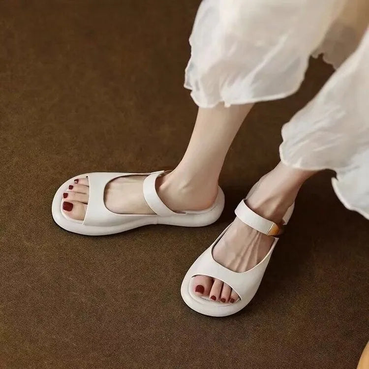 Women's apricot soft leather peep toe flat platform sandals with rubber sole on a white background.
