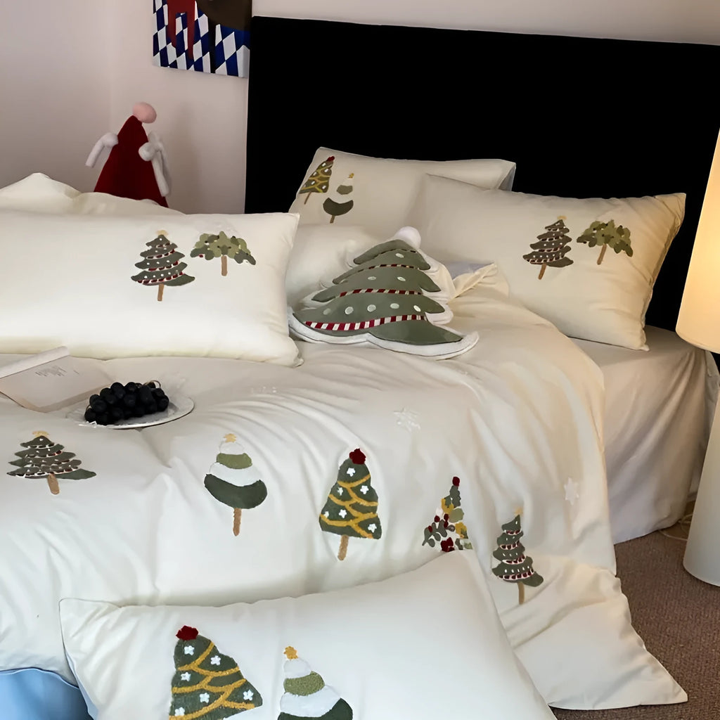Four-piece cotton bedding set with Christmas tree towel embroidery pattern showing duvet cover, bed sheet, and pillowcases