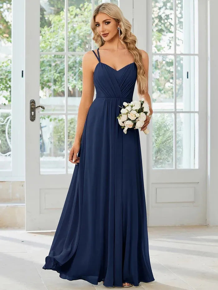 Women's long pleated sleeveless A-line dress in light green, shown on a mannequin.