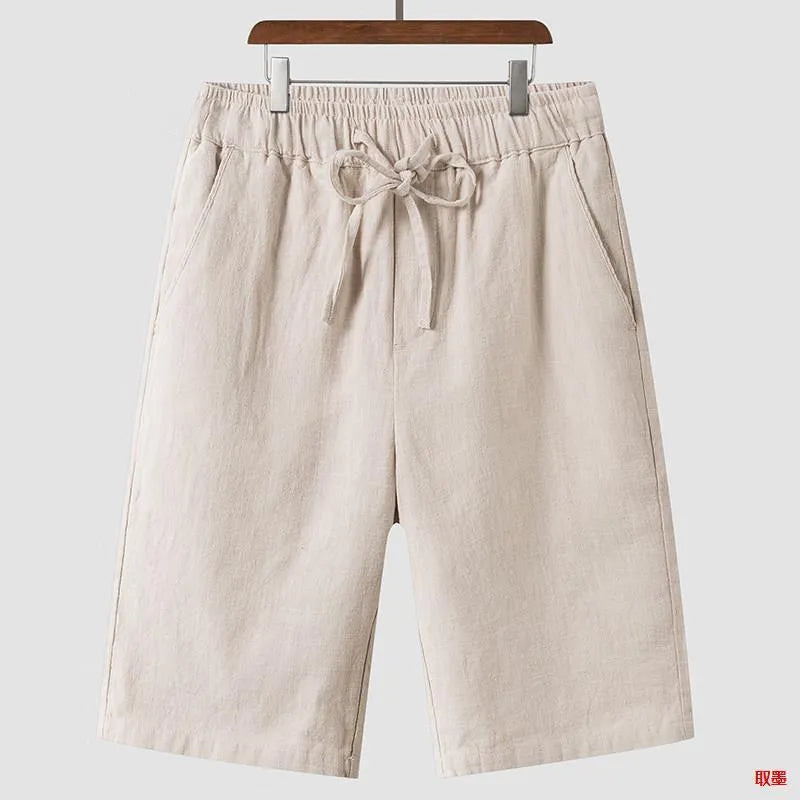 Man wearing beige linen cropped shorts with a loose fit and elasticated waist