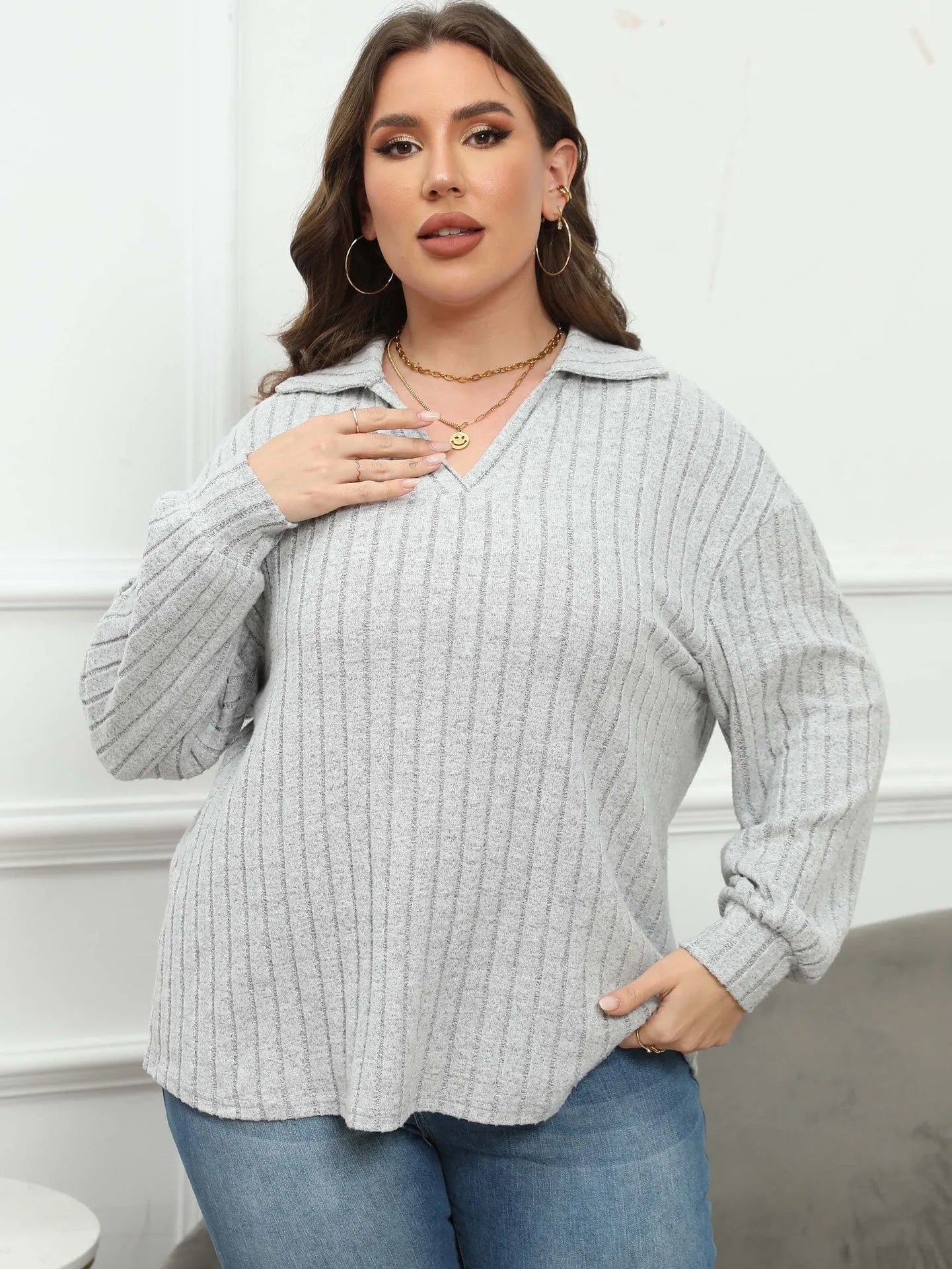 Women's plus size grey polo collar fleece shirt with lantern sleeves on a hanger