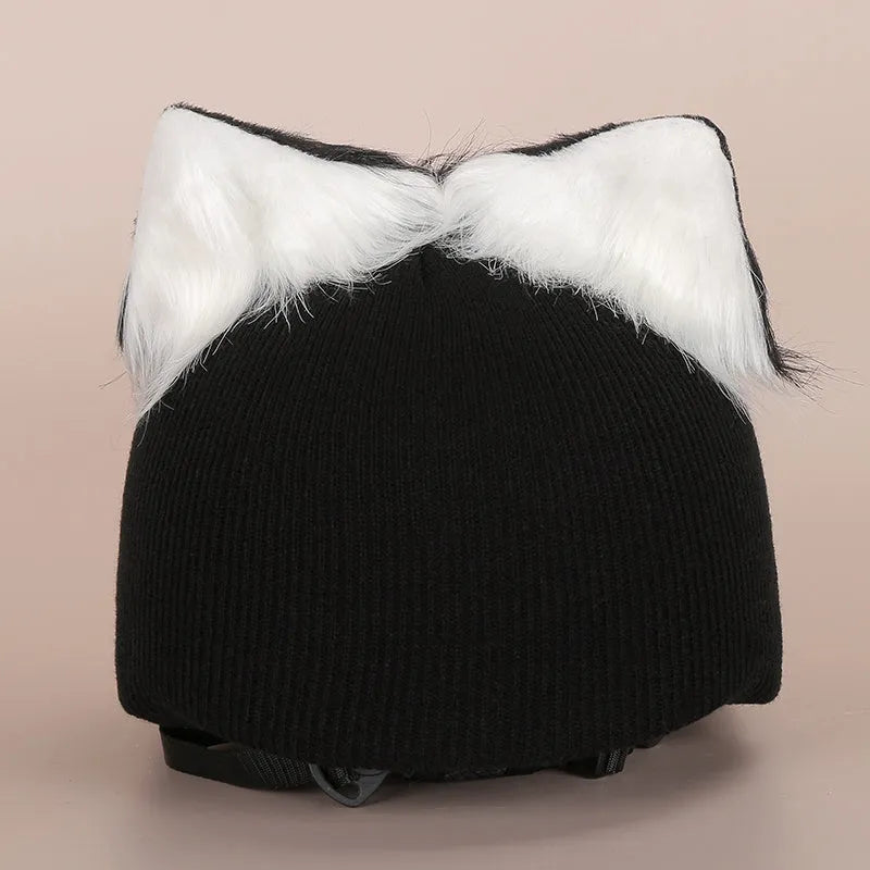 Plush fabric ski helmet decoration with cartoon design on a black ski helmet.