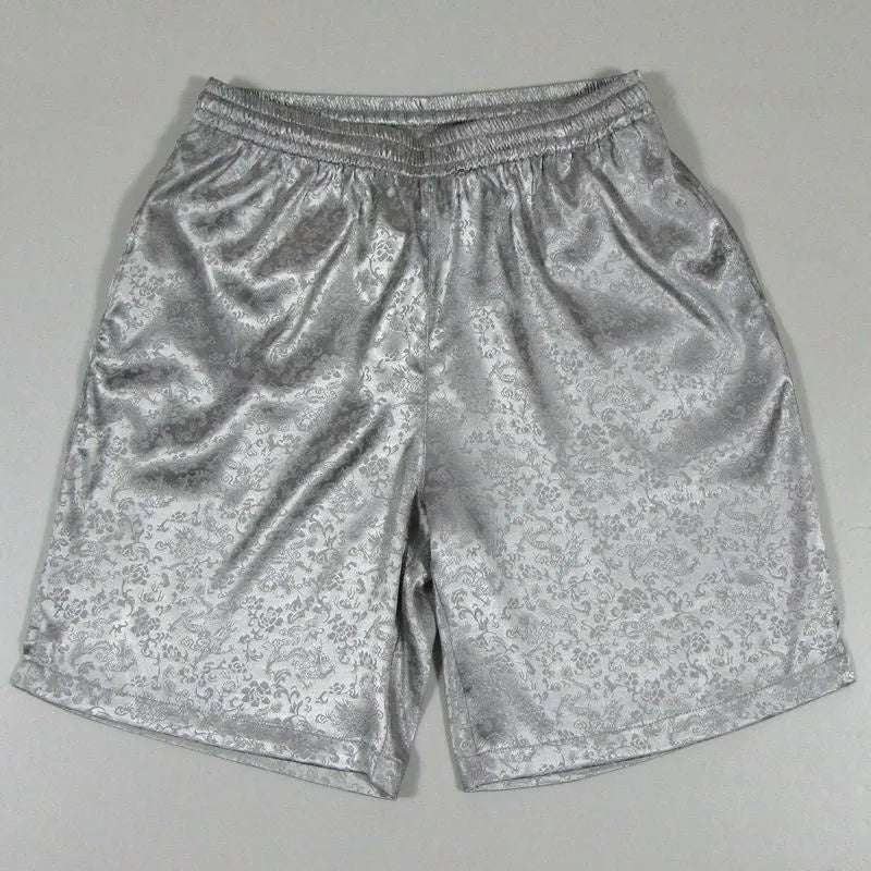 Men's black Tang suit shorts with a white drawstring elastic waistband laid flat.