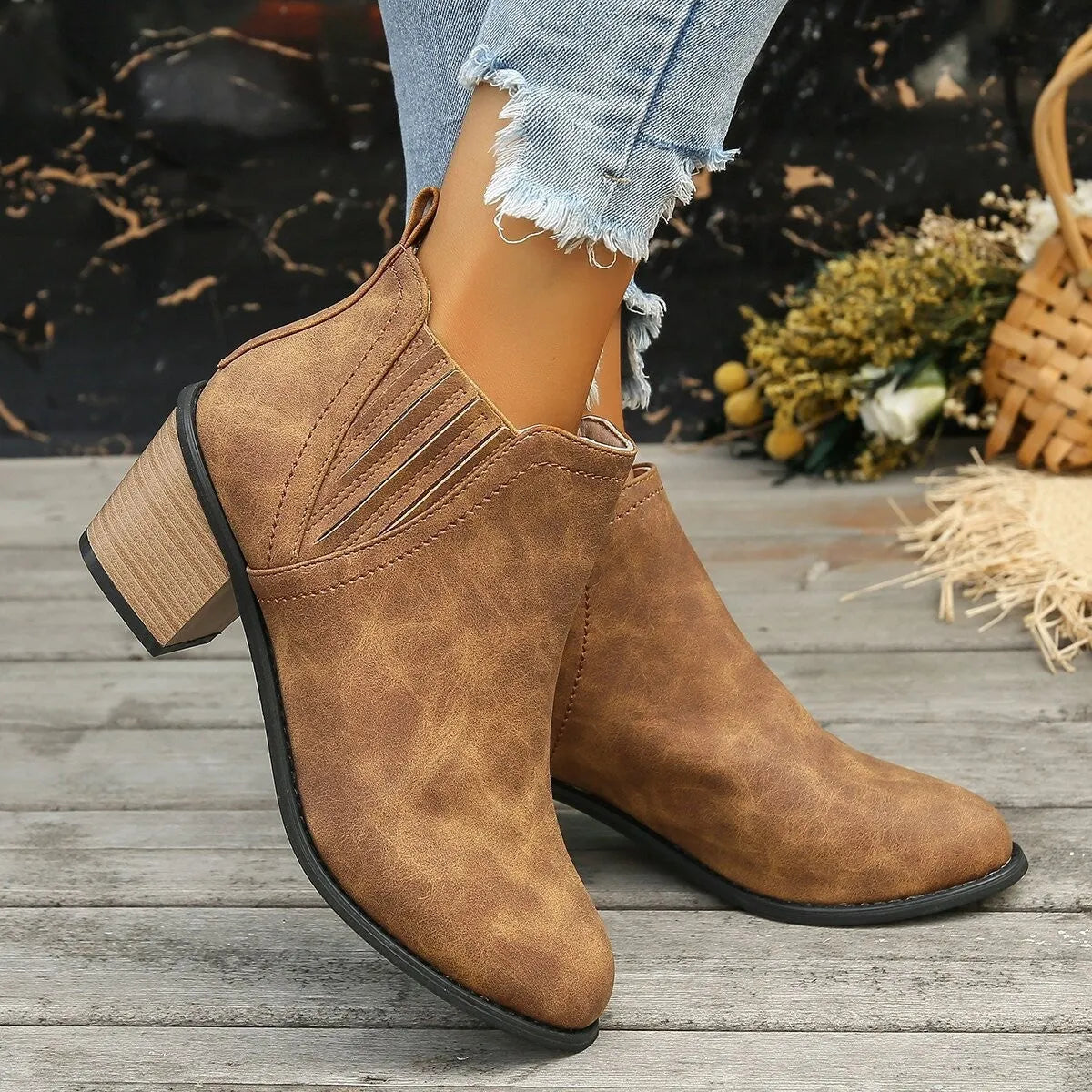 Black women's ankle boots with a pointed toe, thick square low heel, and slip-on design on a white background.