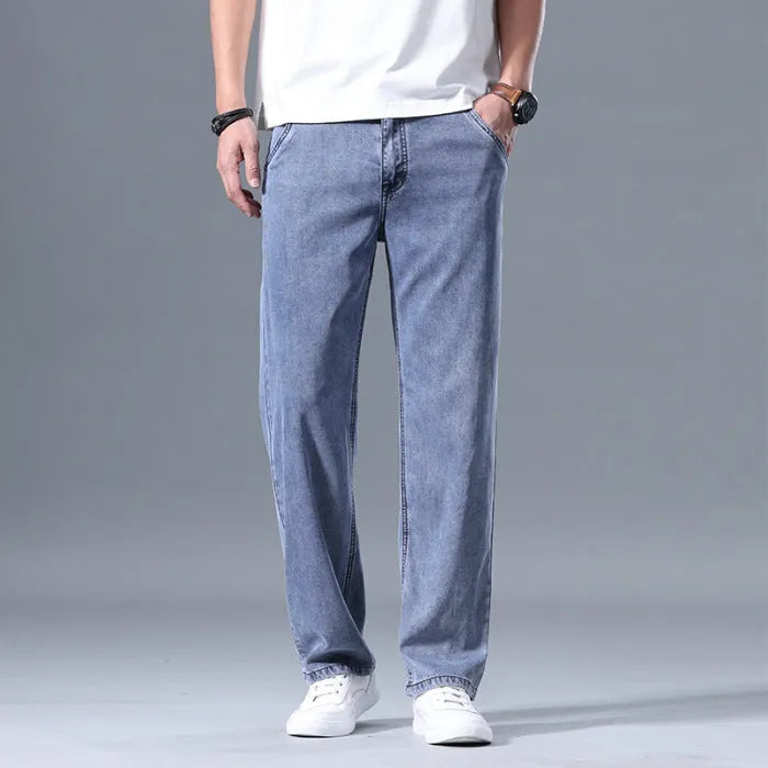 Man wearing loose fit light blue straight-leg lyocell jeans with a zip fly.