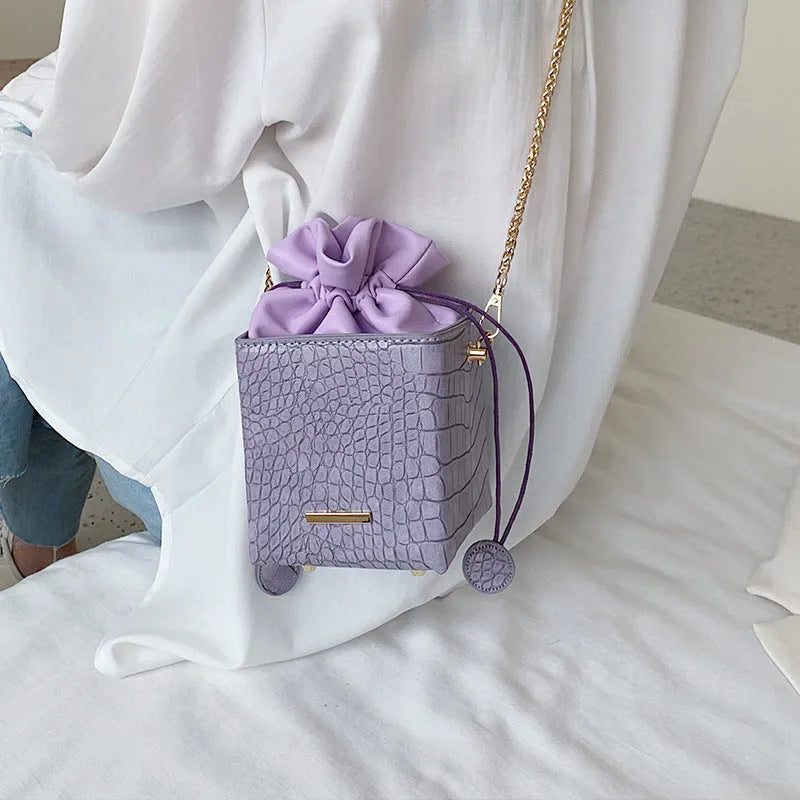 Women's small one shoulder messenger bag with chain strap in bucket style design
