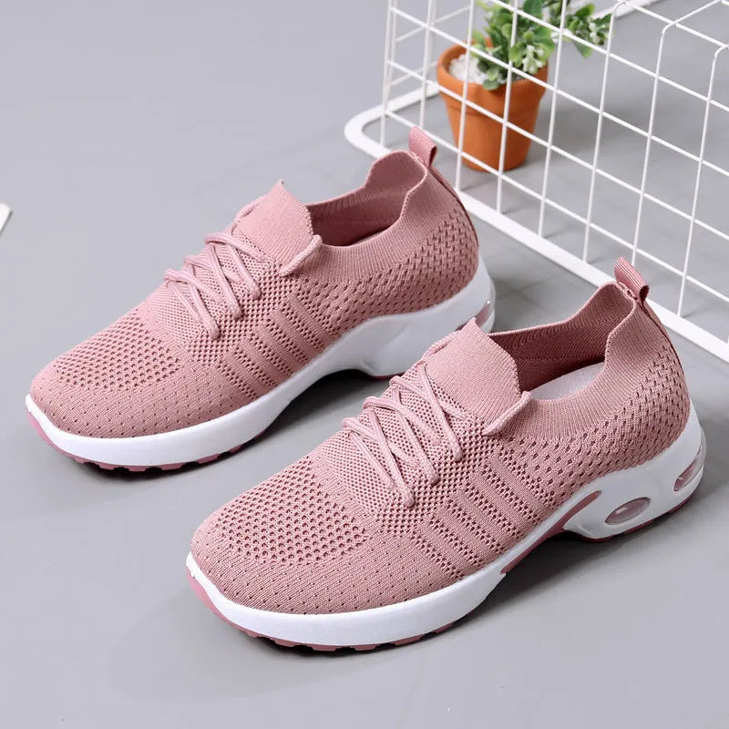 Women's black mesh casual sneaker with round toe and white non-slip PVC sole, shown from the side.