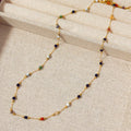 Gold titanium steel necklace with natural stone pendant on female model