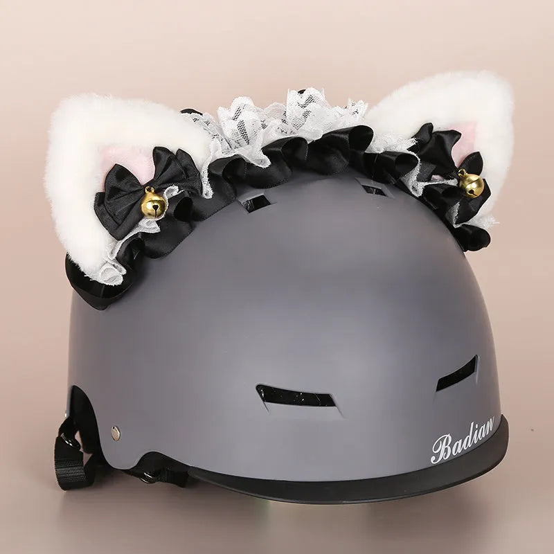 Plush fabric ski helmet decoration with cartoon design on a black ski helmet.