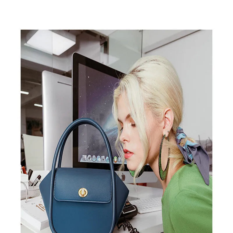 Soft cow leather wing-shaped tote handbag with a buckle and cross-body strap in four colour options.
