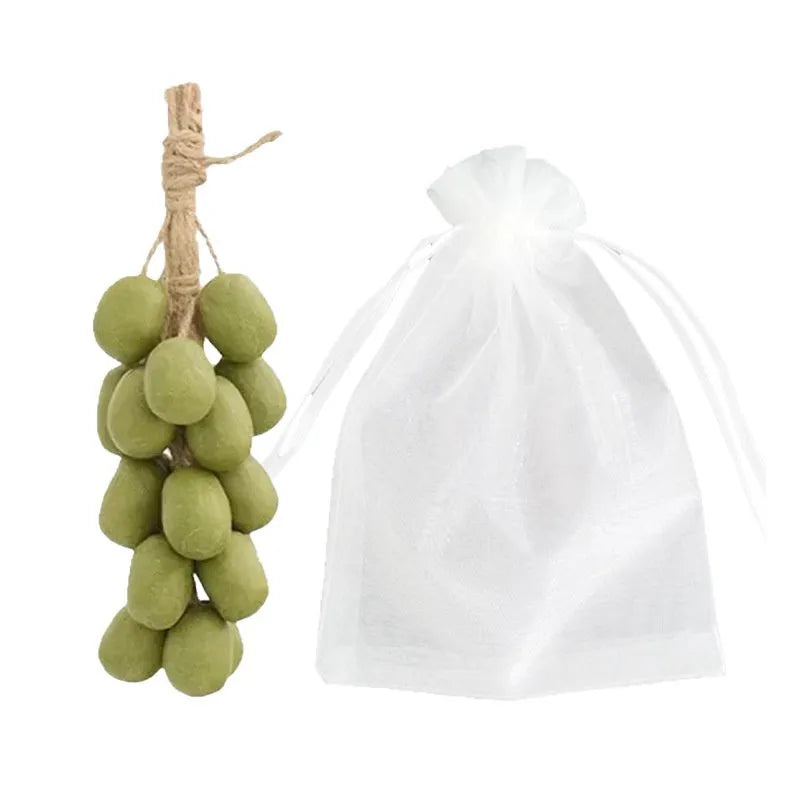 Handmade grape soap bars in black, green, and purple grape scents alongside litchi soap, with gift box and mesh bag packaging